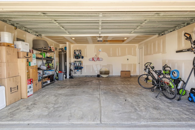 garage featuring water heater and a garage door opener