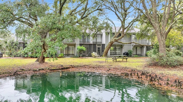 back of house featuring a water view