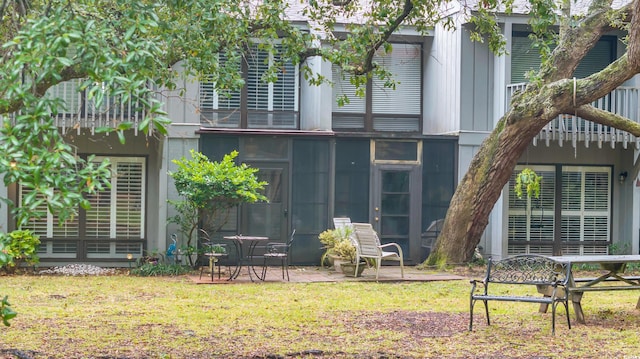 rear view of property with a lawn