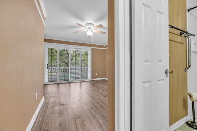 interior space featuring hardwood / wood-style floors, a textured ceiling, and ornamental molding