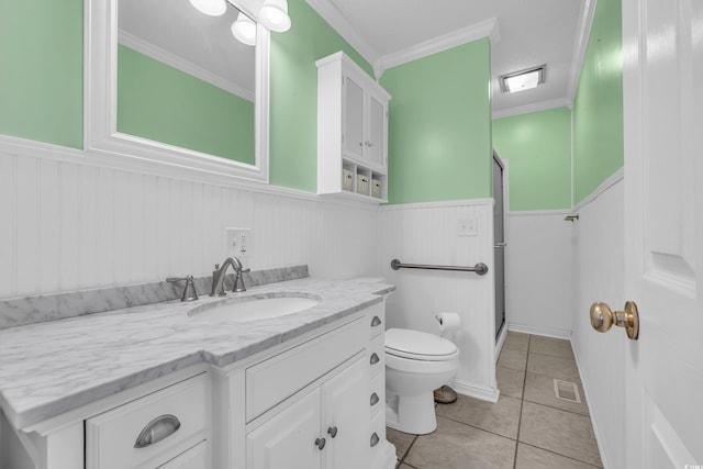 bathroom featuring tile patterned flooring, toilet, an enclosed shower, and crown molding