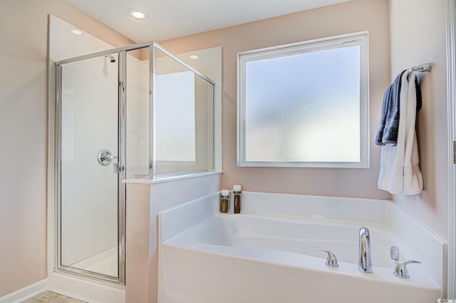 bathroom with shower with separate bathtub