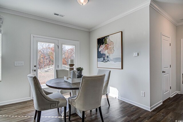 dining area featuring crown molding and dark hardwood / wood-style floors