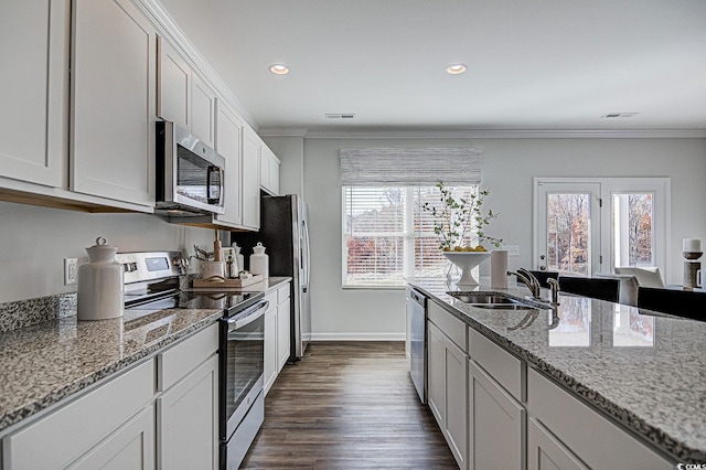 kitchen featuring stainless steel appliances, crown molding, sink, white cabinetry, and dark hardwood / wood-style flooring