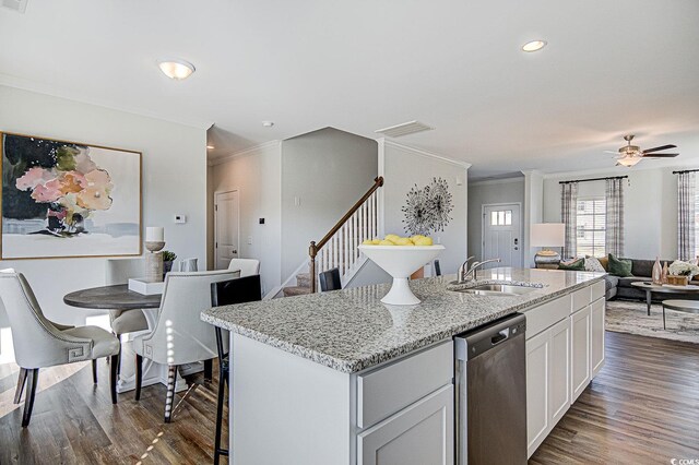 kitchen with white cabinetry, a kitchen island with sink, dishwasher, dark wood-type flooring, and sink