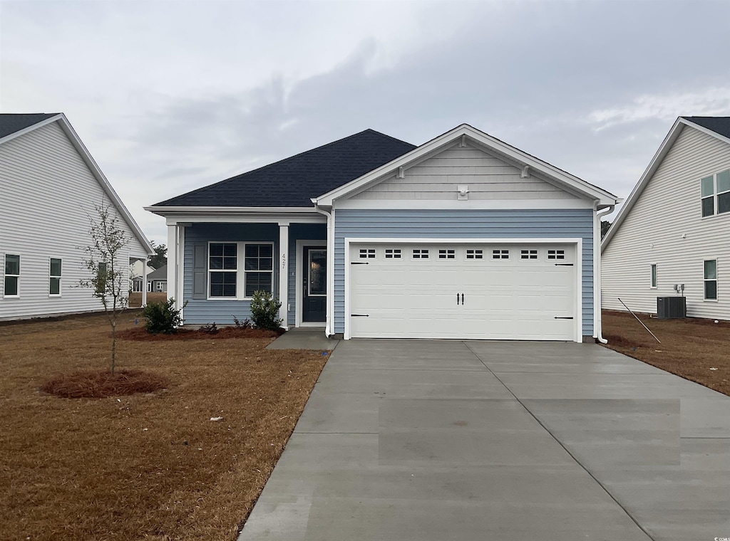 view of front of house with a front lawn and a garage