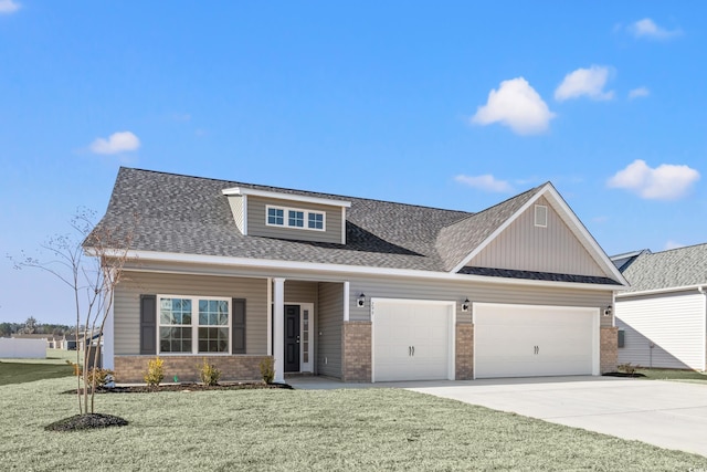 view of front of property featuring a garage, a porch, and a front lawn