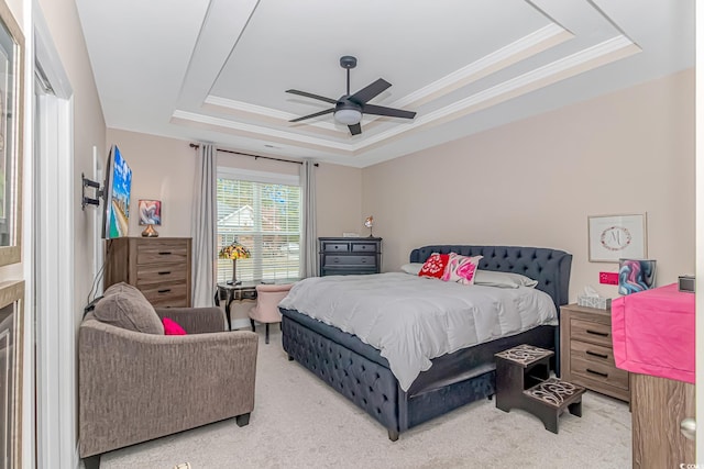 bedroom with ceiling fan, ornamental molding, carpet, and a tray ceiling