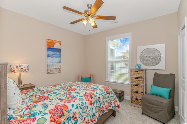 bedroom with light colored carpet and ceiling fan