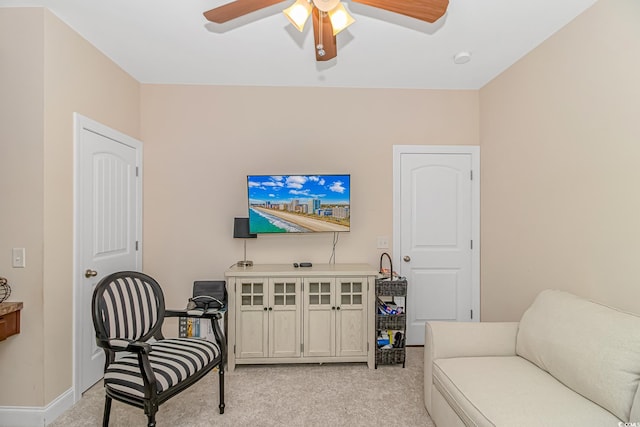 sitting room with light carpet and ceiling fan