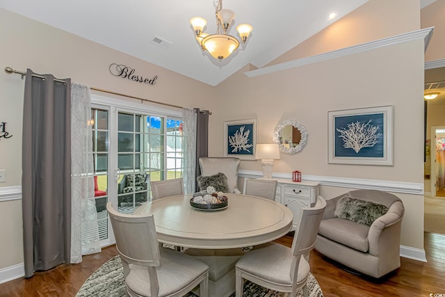 dining space with lofted ceiling, dark hardwood / wood-style floors, and a notable chandelier