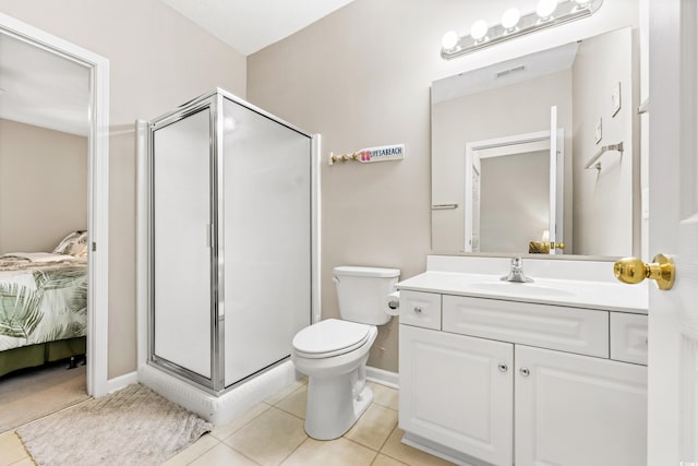 bathroom with vanity, tile patterned flooring, toilet, and an enclosed shower