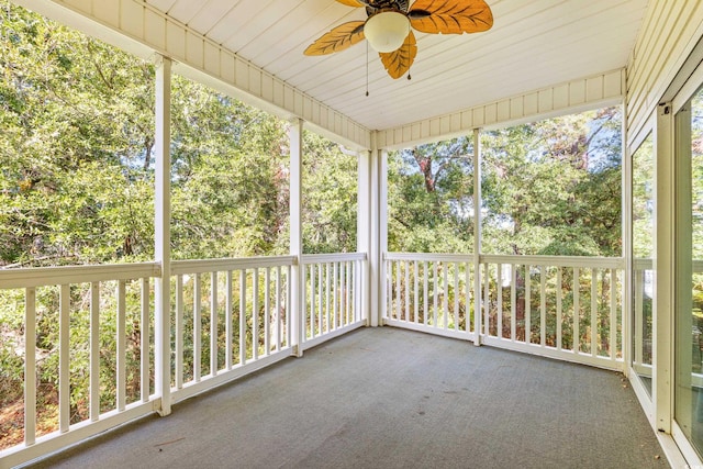 unfurnished sunroom with wood ceiling and ceiling fan