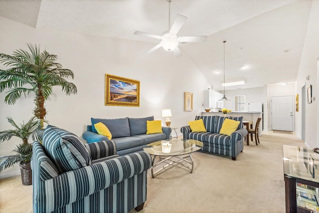 carpeted living room featuring a textured ceiling, ceiling fan, and vaulted ceiling