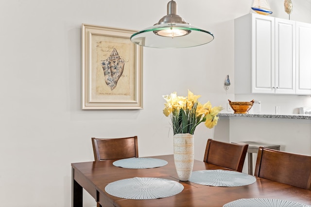 dining space featuring wood-type flooring