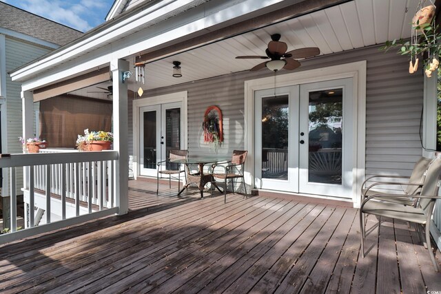 wooden terrace with ceiling fan and french doors