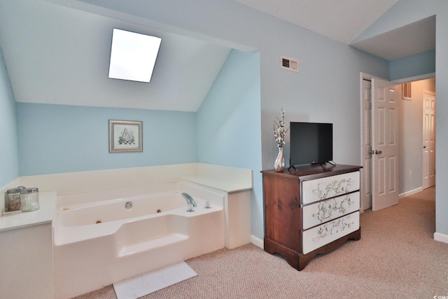 bathroom with a bathing tub and lofted ceiling