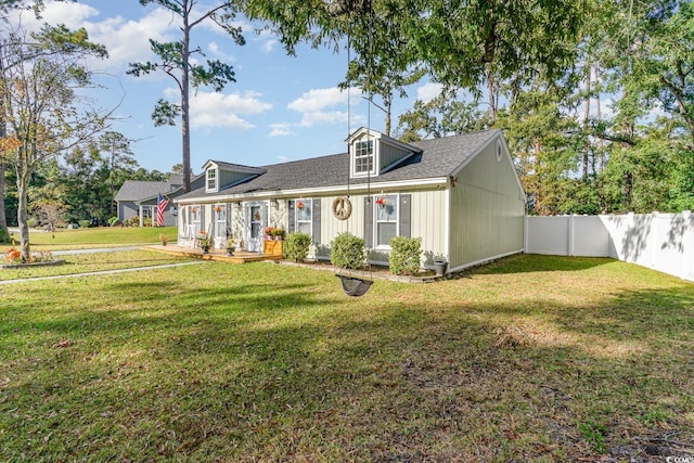 cape cod house with a front lawn