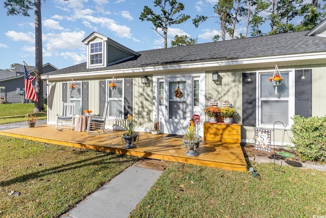 view of front of home with a front lawn and a wooden deck