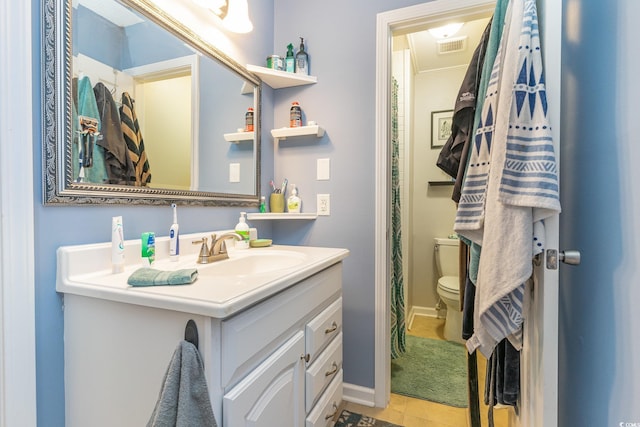 bathroom with vanity, toilet, and tile patterned floors