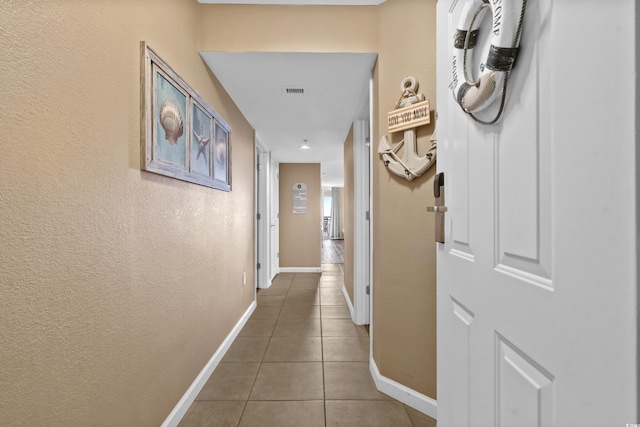 corridor with tile patterned flooring