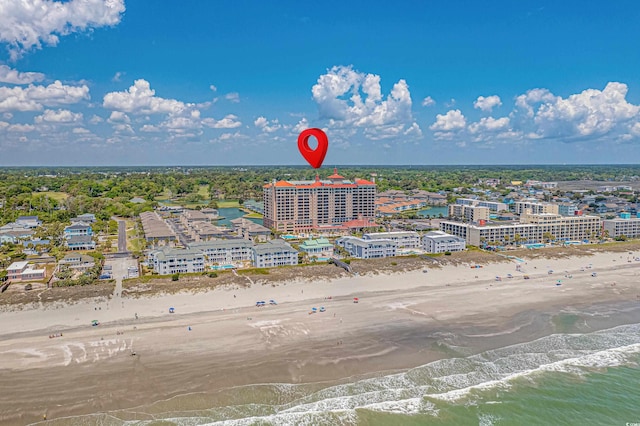 drone / aerial view featuring a water view and a view of the beach