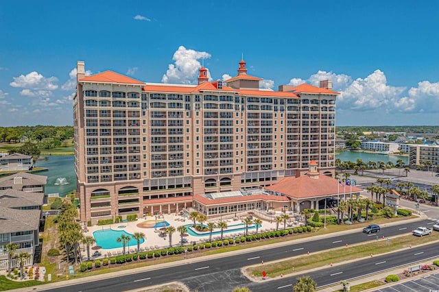 view of property featuring a community pool and a water view