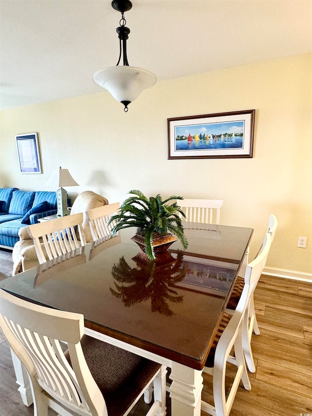 dining space with hardwood / wood-style flooring