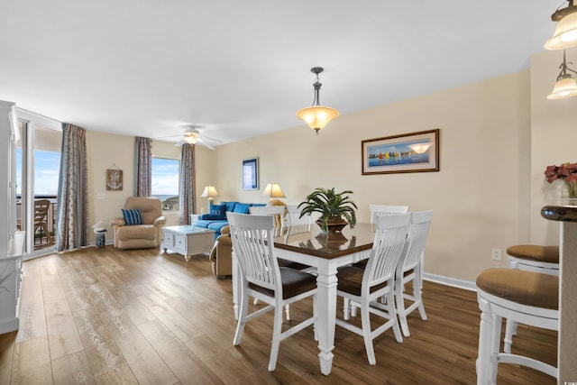 dining space with hardwood / wood-style flooring and ceiling fan