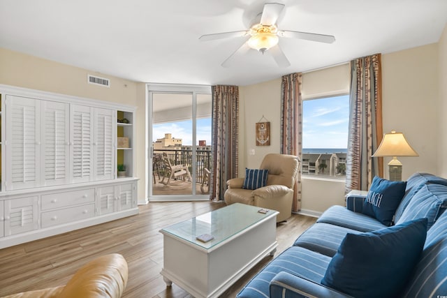 living room featuring light hardwood / wood-style floors and ceiling fan