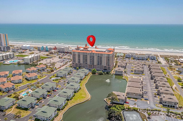 drone / aerial view with a water view and a view of the beach