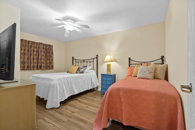 bedroom with light hardwood / wood-style flooring and ceiling fan