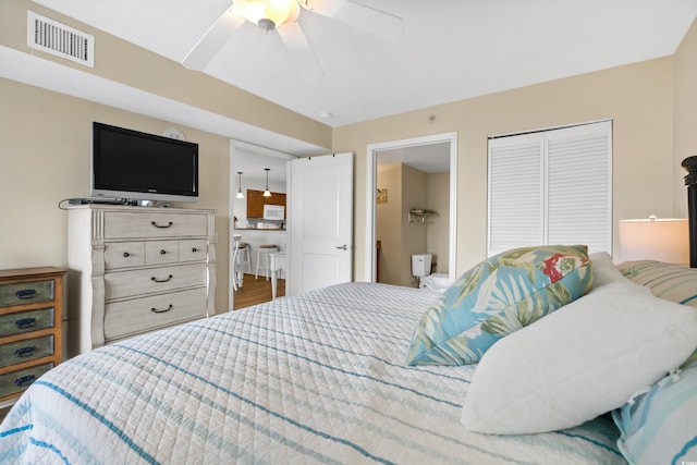 bedroom featuring a closet, dark wood-type flooring, and ceiling fan