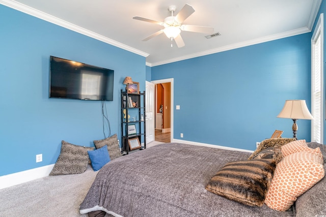 carpeted bedroom with ornamental molding and ceiling fan