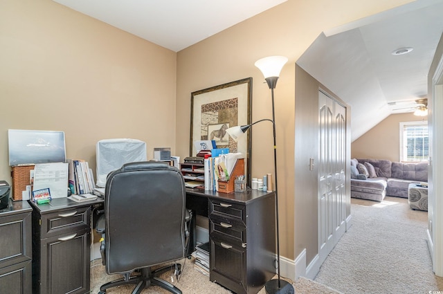 carpeted office with ceiling fan and vaulted ceiling