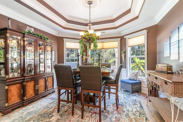 dining room featuring a wealth of natural light, crown molding, and hardwood / wood-style flooring