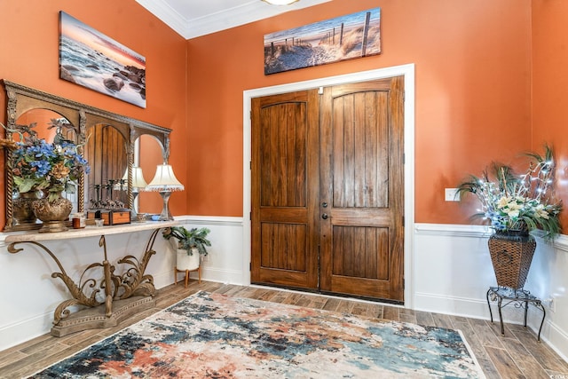 entryway with crown molding and dark hardwood / wood-style floors