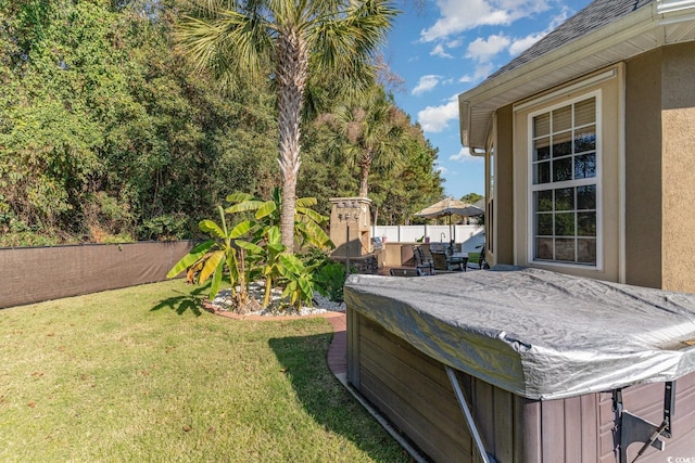 view of yard featuring a hot tub and a patio