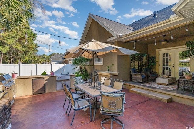 view of patio / terrace with french doors, an outdoor kitchen, and an outdoor hangout area