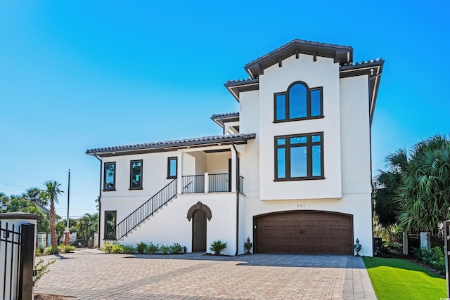 mediterranean / spanish-style house with a garage