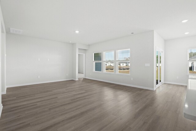 unfurnished living room with dark hardwood / wood-style flooring