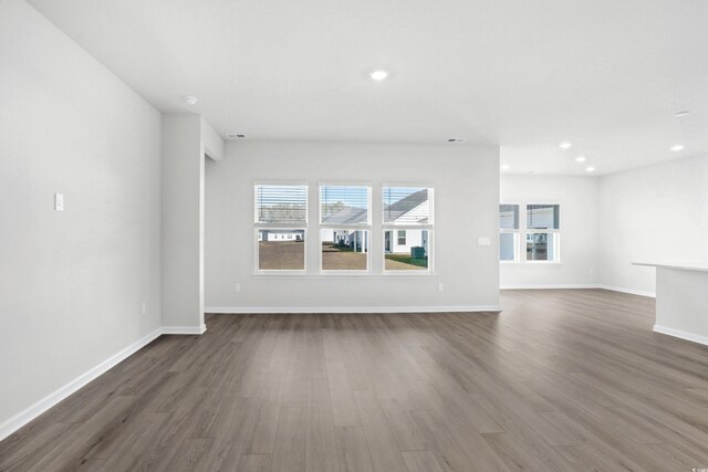 unfurnished living room featuring dark hardwood / wood-style floors