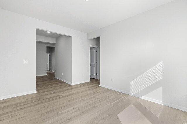 unfurnished room with light wood-type flooring