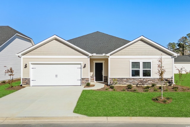 view of front of property with a front yard and a garage