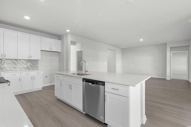 kitchen with white cabinetry, a kitchen island with sink, dishwasher, and sink