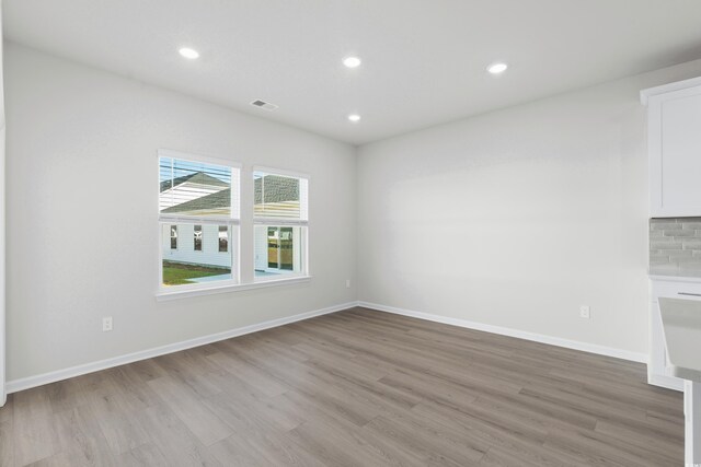 empty room with light hardwood / wood-style floors