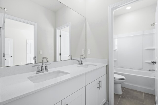 full bathroom with tile patterned floors, vanity,  shower combination, and toilet