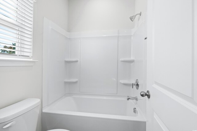 bathroom featuring toilet and tub / shower combination