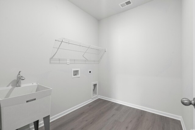 laundry area featuring hookup for an electric dryer, dark hardwood / wood-style flooring, sink, and washer hookup