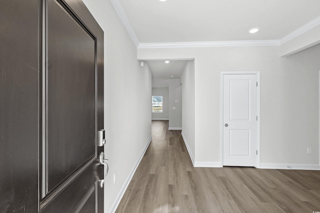 hall featuring light hardwood / wood-style floors and crown molding